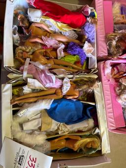 two boxes of assorted Barbie dolls