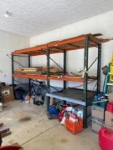 two sections of pallet shelving and assorted lumber