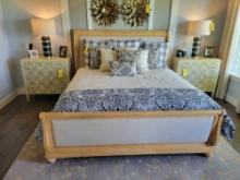 King size bed frame with padded sleigh style headboard and light wood trim