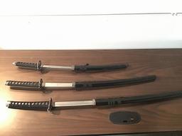 Three black samurai swords