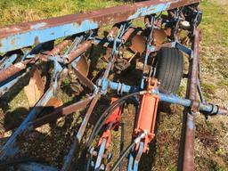 Melroe 7-bottom 18in on land hitch trailer plow w/ spring cushion coulters.