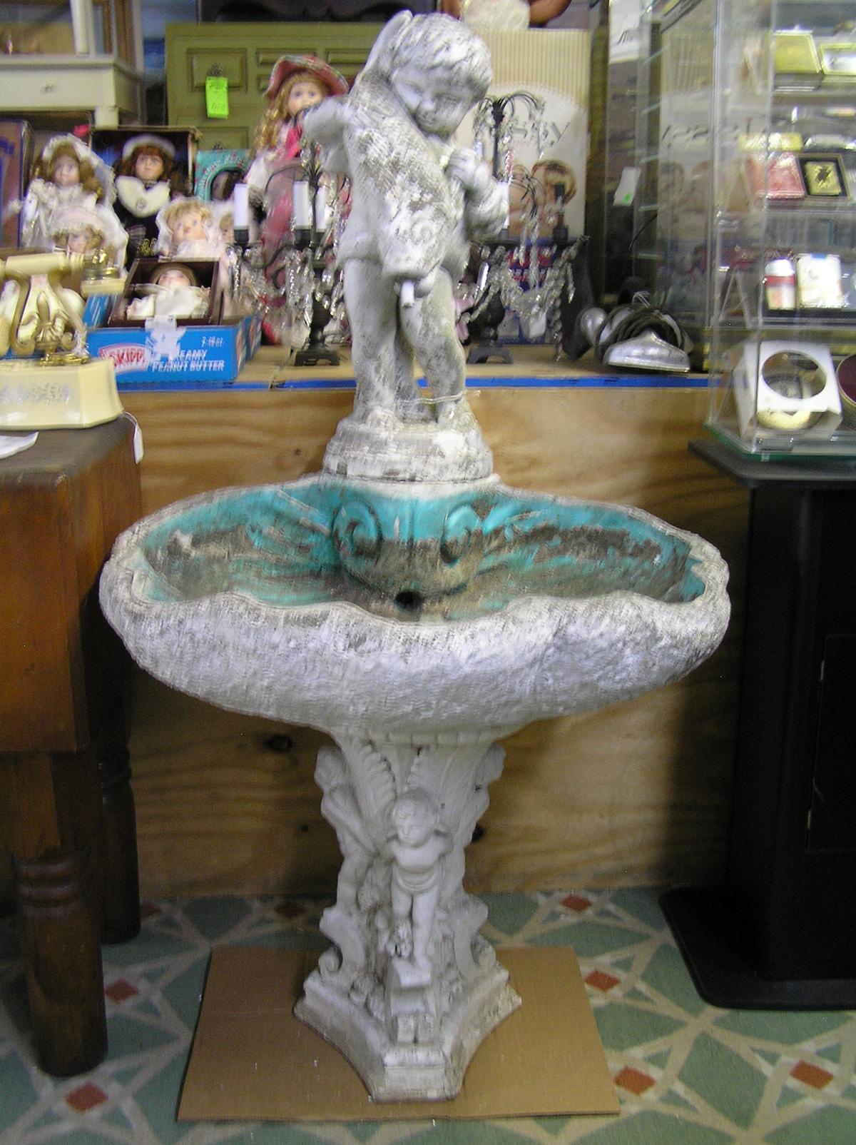 Antique seashell shaped bird bath