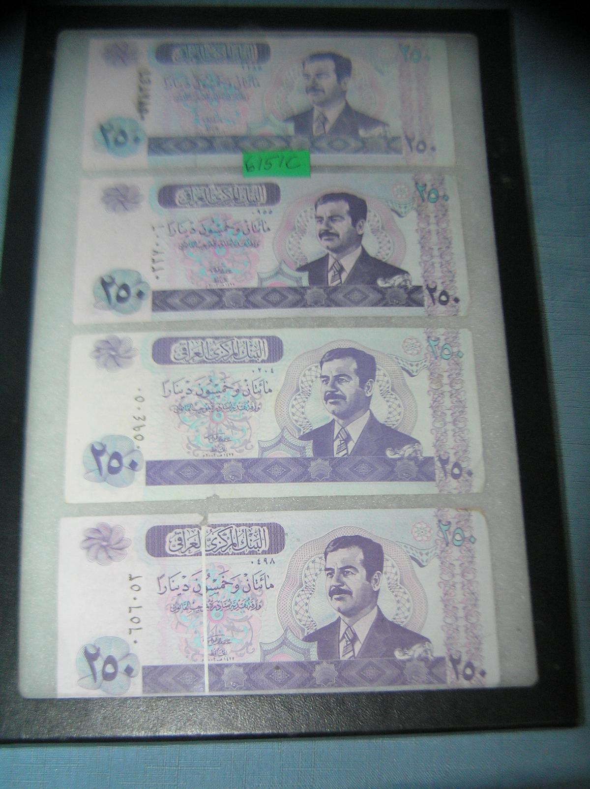 Group of Iraqui currency featuring Saddam Hussien