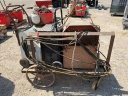 Portable Welder on wooden cart w/metal wheels