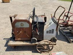 Portable Welder on wooden cart w/metal wheels