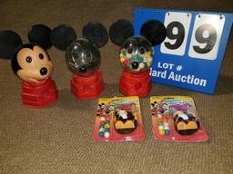 Three Mickey Mouse gumball dispensers and two Mickey Gumball pocket packs