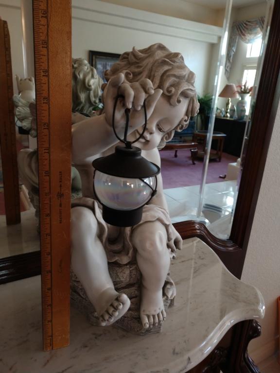 Cherub with a lantern table top statue