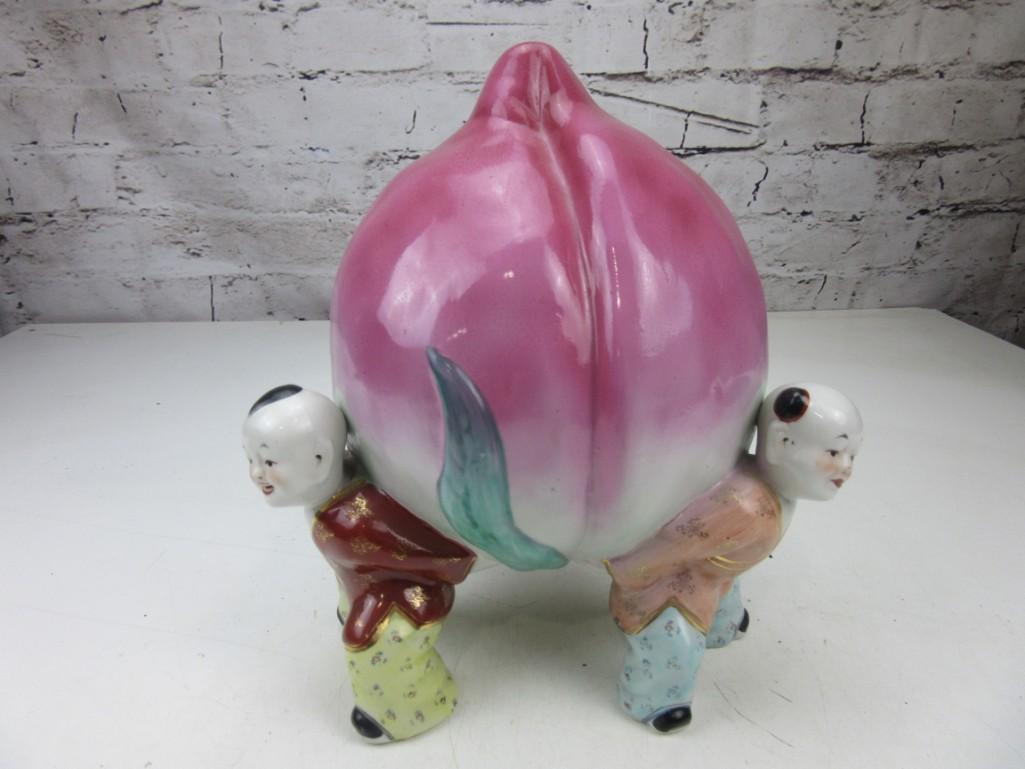 Porcelain Peach Held by Three Chinese Children