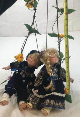 2 Porcelain Girl and Boy Dolls on Hanging Bench