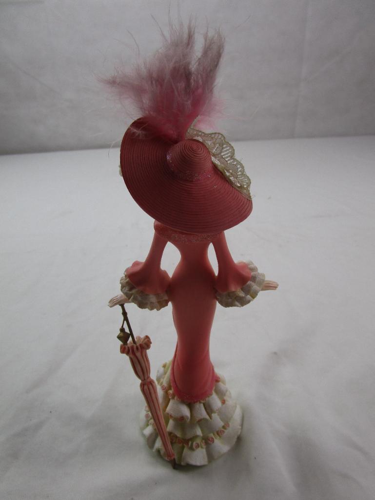 Ceramic fancy lady figurine with a parasol; breast cancer commemorative by Thomas Kinkade......