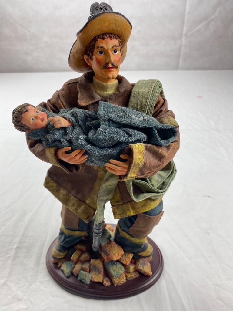 Cloth Fireman figure carrying small child