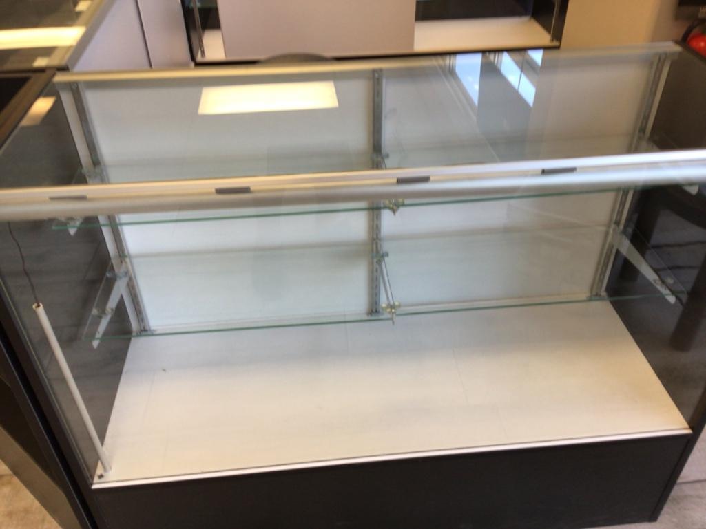 nice display case with 2 glass selves, has glass top, 48 inches long, 18 inches deep and 38 inches