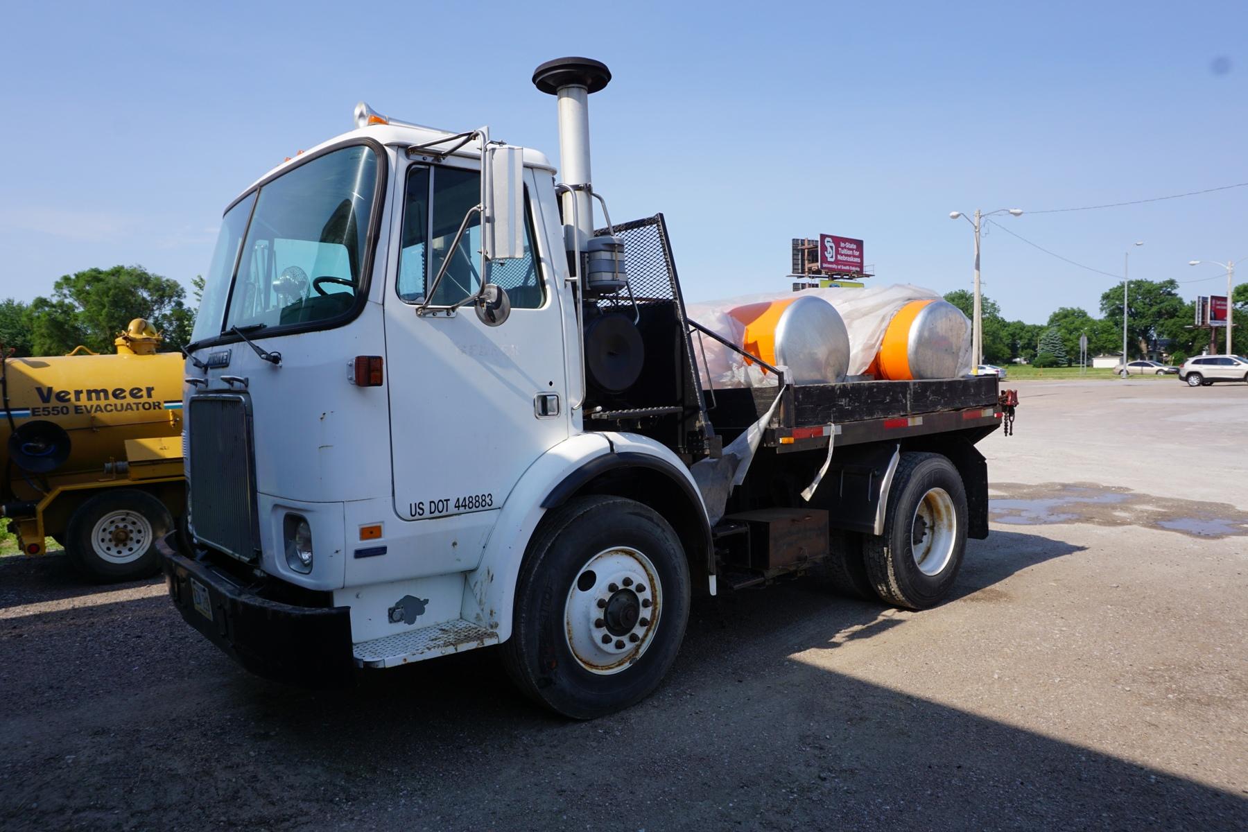 1987 White Single Axle Flatbed Truck.