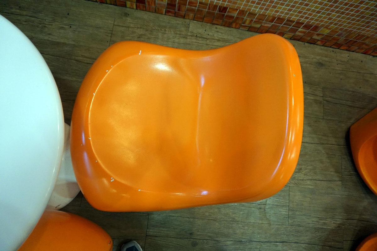 Round Plastic Table & (3) Orange Chairs.