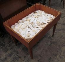 Hundreds of Sand Dollars under Glass Lamp Table