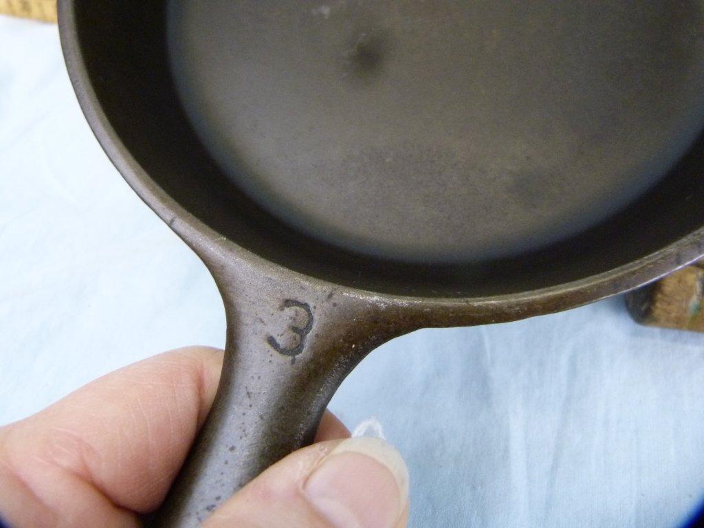 Cast iron skillet & cornbread pan; wooden spatula