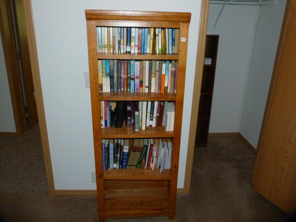 Wooden bookcase with adjustable shelves including books