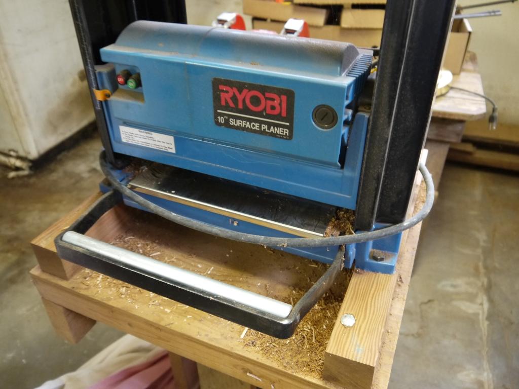 Ryobi AP-10 planer on stand with accessories & manual