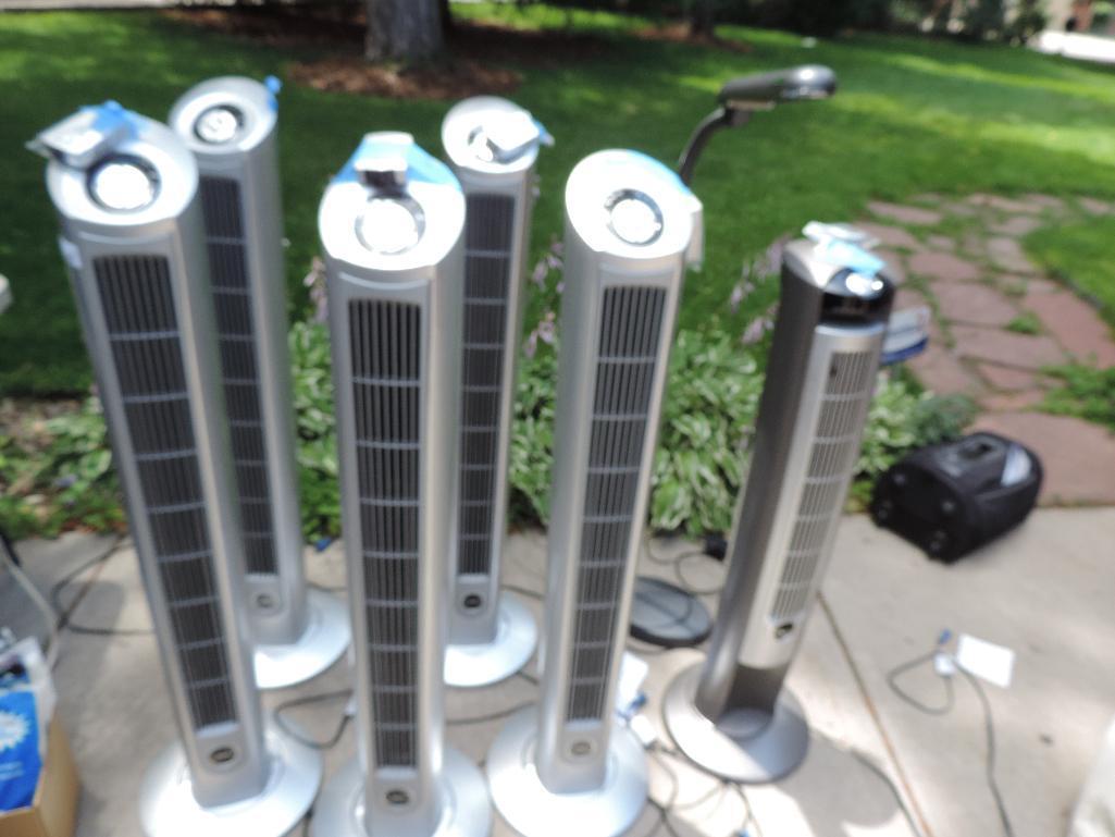 6 48" lasko tower fans with remotes and a Ott-lite lamp all are operable.