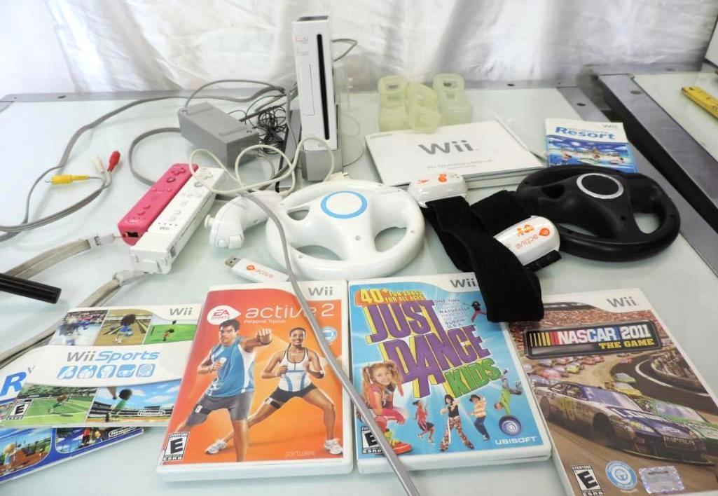 Nintendo Wii console with 2 controllers, 2 wheels, games and more.