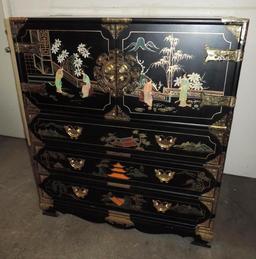 Ornate 6 drawer black lacquer dresser with brass hardware and stone accents.