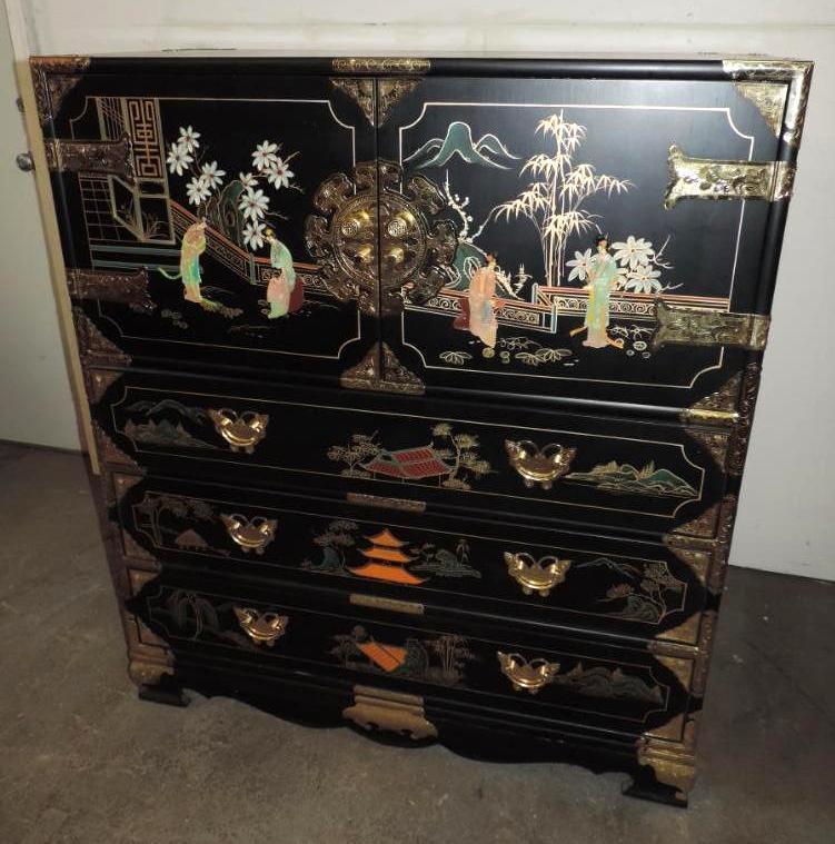 Ornate 6 drawer black lacquer dresser with brass hardware and stone accents.