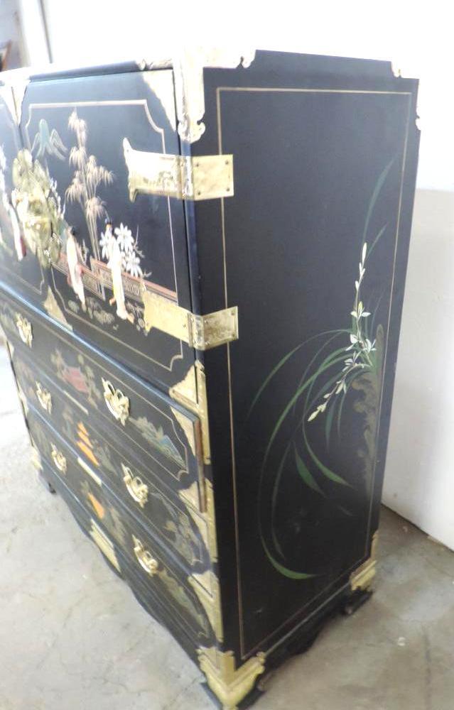 Ornate 6 drawer black lacquer dresser with brass hardware and stone accents.