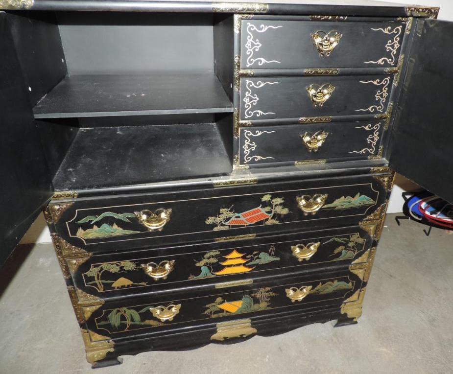 Ornate 6 drawer black lacquer dresser with brass hardware and stone accents.