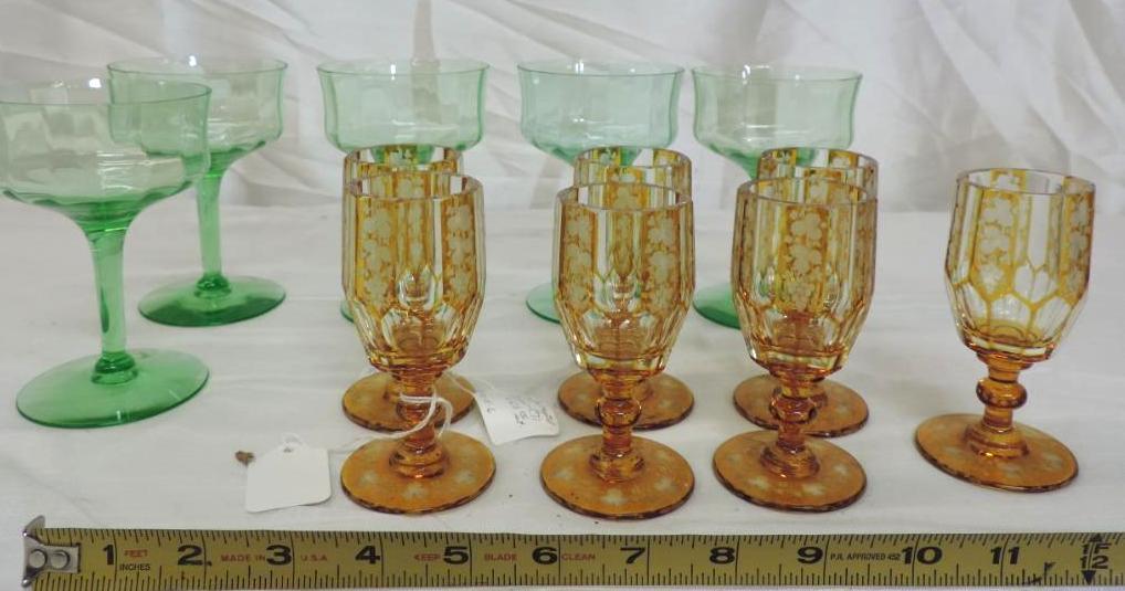Seven amber cut bohemian glasses and 5-5" green depression glasses.