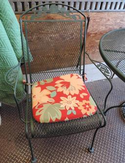 Green metal patio table with 2 chairs.