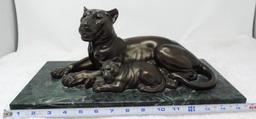 Lion statue with marble base.