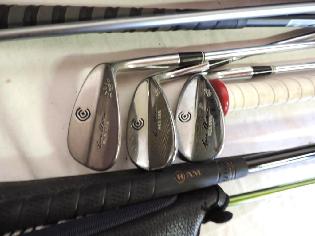 Golf clubs and gear assortment.