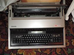 Antique rocking chairs and Panasonic KX-E603 typewriter.