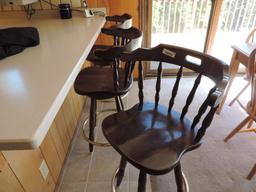 Three wooden barstools.