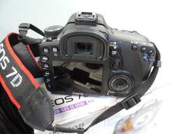 Canon EOS 7D camera with accessories.