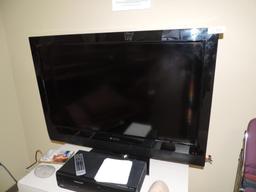 42" Polaroid TV with VCR/DVD player and table.