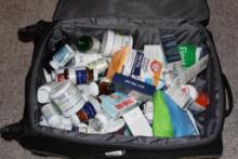 Large Suitcase Filled with Supplements and Personal Care Items